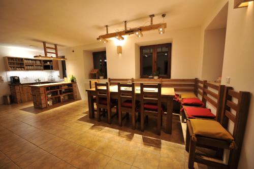 a kitchen and dining room with a table and chairs at Penzion Dvůr in Obora