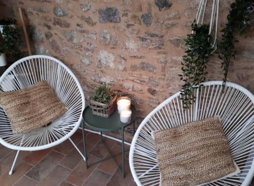 two chairs and a table with a pillow on a patio at Frourio Apartments in Chios