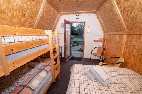 a bedroom with two bunk beds in a tiny house at Seaways glamping, Redwood in Great Driffield