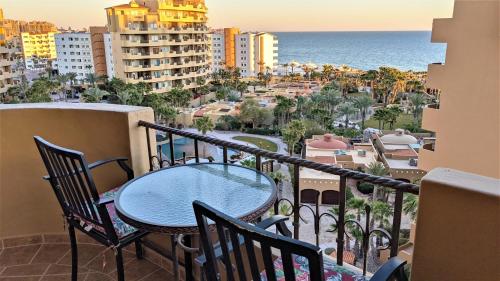 a table and chairs on a balcony with a view of the ocean at Bella Sirena 601-D in Puerto Peñasco