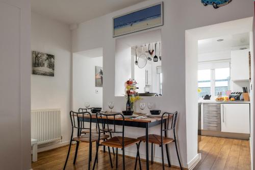 a kitchen with a table and chairs in a room at Conwy View Cottage in Conwy