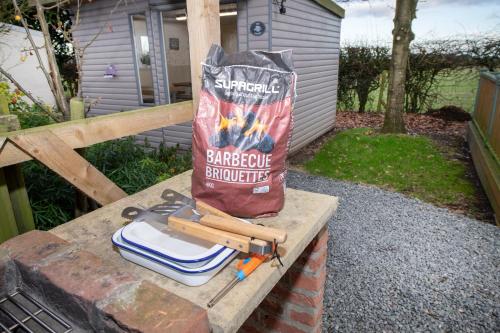 a bag of barbecue barbecue equipment sitting on a table at Seaways glamping, Redwood in Great Driffield