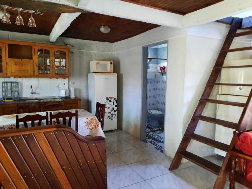 a kitchen with a stairs leading to a kitchen with a refrigerator at Serena in Barra del Chuy