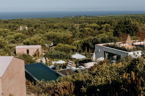 an aerial view of a house with the ocean in the background at Eco-lodge Villa Epicurea in Sesimbra