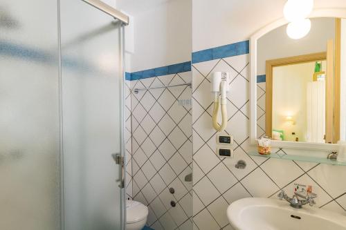 a bathroom with a shower and a toilet and a sink at Stromboli Central Family Apartment - 3 Double Rooms in Stromboli