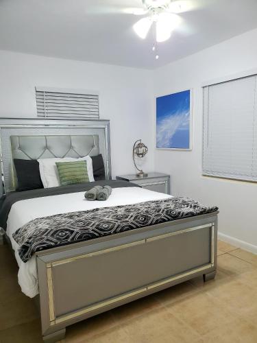 a bedroom with a large bed and a ceiling fan at Singer Island Inn in West Palm Beach