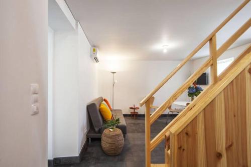 a living room with a staircase and a chair at Casa Azul: A magic place in an authentic space in Mosteiros
