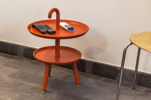 a table with two remote controls on top of a stool at Casa Azul: A magic place in an authentic space in Mosteiros