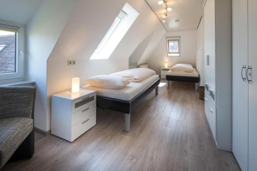 a room with two beds and a window at Unser Haus in Norderney