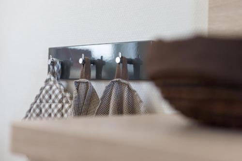 a mirror with purses hanging on a wall at Unser Haus in Norderney