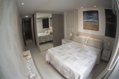 En eller flere senge i et værelse på Flat Cabo Branco - Alto Padrao