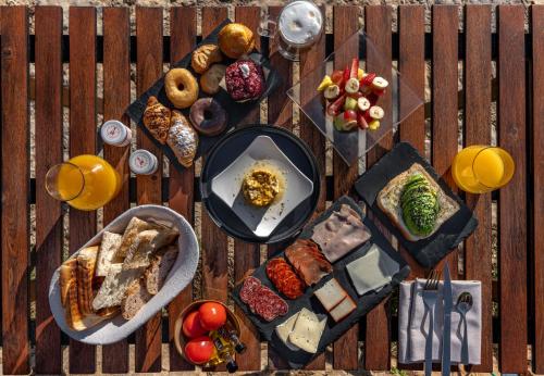 a table with plates of food on a wooden deck at Hotel Mas Mariassa in Pratdip