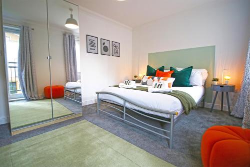 a bedroom with a large bed and a mirror at Dock House - 5 Bedroom House - Sleeps 7 in Newport
