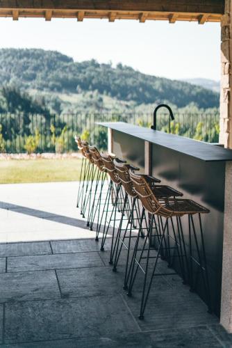 a row of chairs sitting next to a counter at La ferme d'Edouard - Les Fermes Ardéchoises in Labatie-dʼAndaure