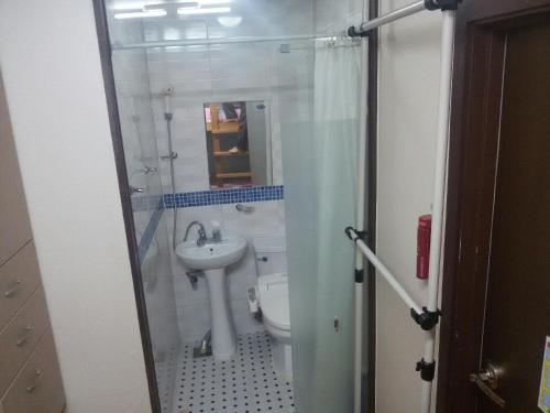 a small bathroom with a toilet and a sink at 아이원리빙텔 in Yongin