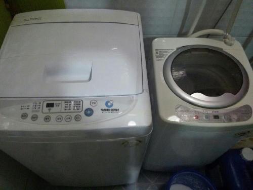 a toilet and a washing machine in a bathroom at 아이원리빙텔 in Yongin