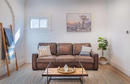 a living room with a brown couch and a table at Plush 2-bed apt in Riverside Heights! in Reno