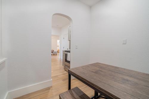 a dining room with a table and a kitchen at Plush 2-bed apt in Riverside Heights! in Reno