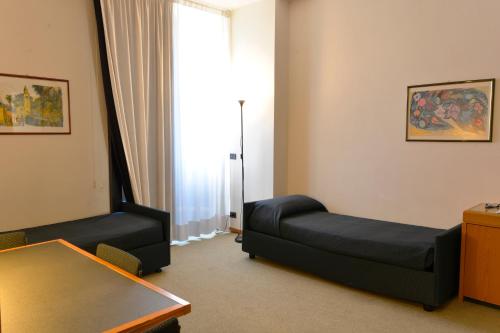 a living room with a couch and a table at Grand Hotel Tiziano E Dei Congressi in Lecce