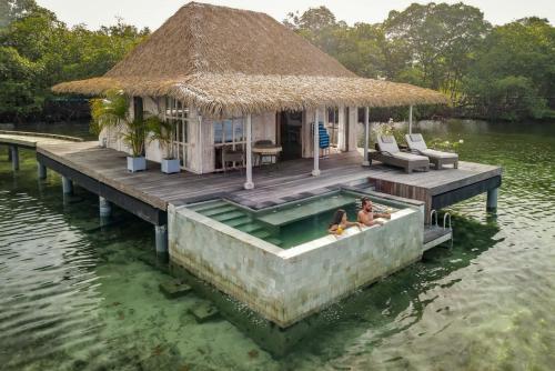 a small house on a dock in the water at Nayara Bocas del Toro in Bocas del Toro