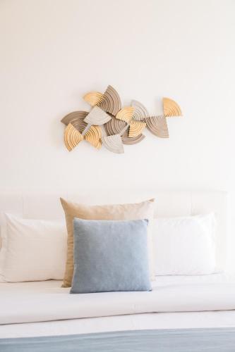 a room with a bed with a pillow and a wall at Naro Suites and Rooms in Bacoli