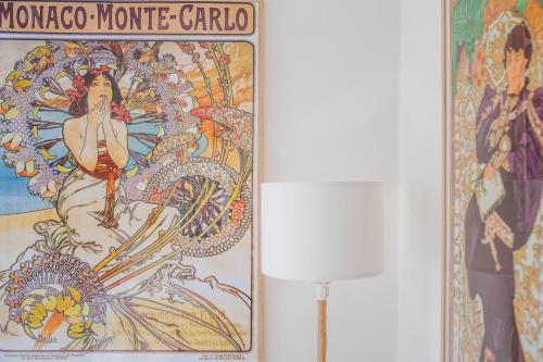 Un dipinto di una donna e di un drago accanto a una lampada. di Naro Suites and Rooms a Bacoli