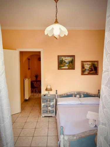 a bedroom with a bed and a chandelier at Sofia's House in Sivota