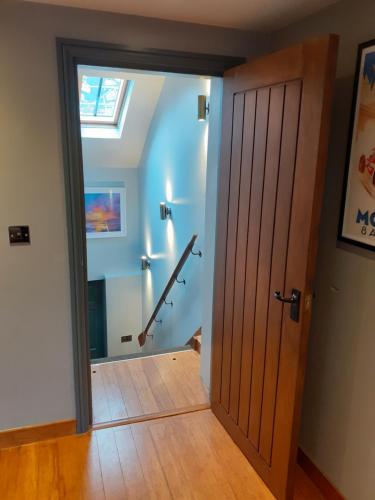 a room with a sliding door and a staircase at Riverside 2 bed apartment Bewdley Worcestershire in Bewdley
