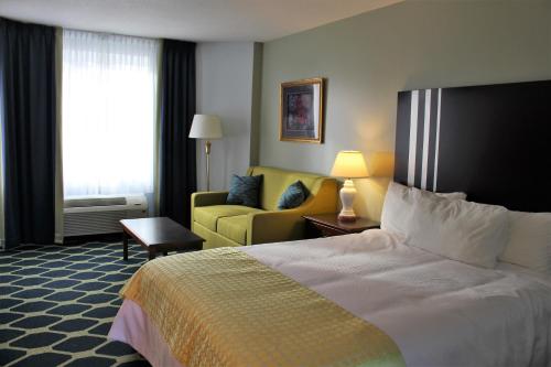 a hotel room with a bed and a couch at Auberge Gisele's Inn in Baddeck