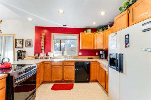 a kitchen with wooden cabinets and a black refrigerator at A House For All Seasons in McCall