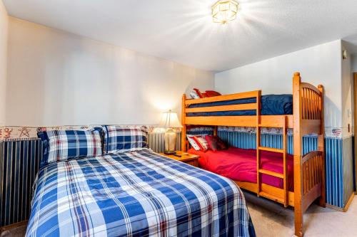 a bedroom with a bed and a bunk bed at A House For All Seasons in McCall