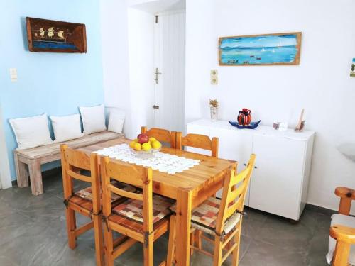 a dining room with a wooden table and chairs at Anastasia's house Ysterni in Isterni
