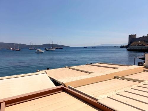 a group of wooden docks with boats in the water at Gözen Hotel in Bodrum City