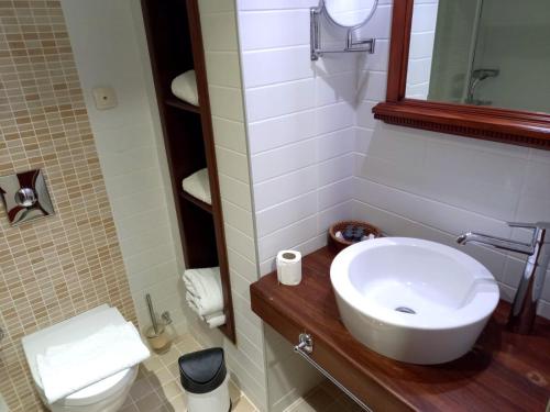 a bathroom with a white sink and a toilet at Gözen Hotel in Bodrum City