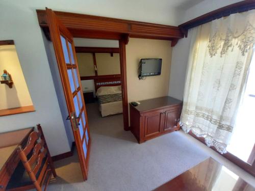 a small room with a door and a bedroom at Gözen Hotel in Bodrum City