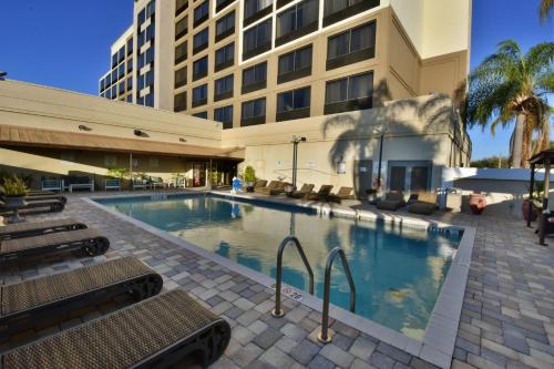 オーランドにあるHoliday Inn Orlando East-UCF Area, an IHG Hotelの建物前の大型スイミングプール