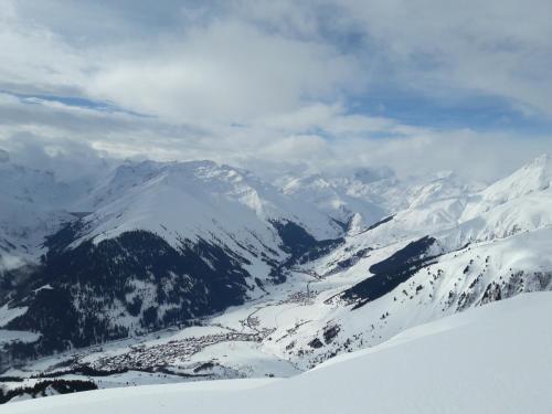 a view of a snow covered mountain range with a valley at Ferienwohnung Casa Ursina in Sedrun