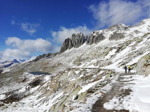 two people walking up a snow covered mountain at Ferienwohnung Casa Ursina in Sedrun
