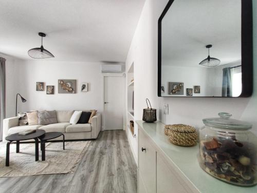 a living room with a couch and a table at ARTE Playa la Caleta Grupo AC Gestion in Cádiz
