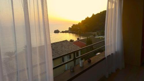 a view of the ocean from a hotel window at Corfu Dream Holidays Villas in Glyfada