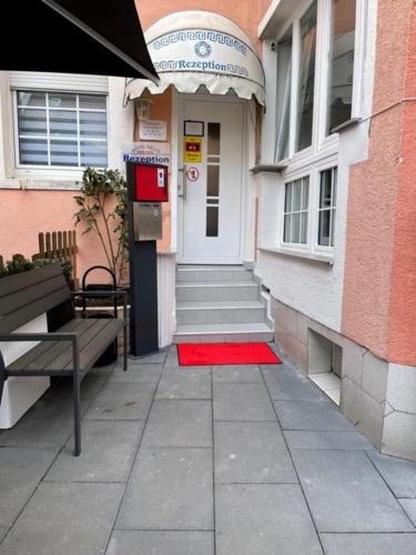 a building with a red rug in front of the door at Hotel Nello in Offenbach