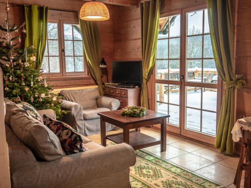 a living room with a christmas tree and a television at Leśne uroczysko in Cisna