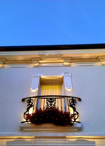 a building with a balcony with flowers on it at Hotel Lido in Rimini