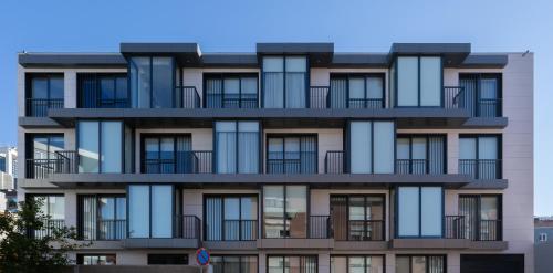 an apartment building with balconies on the side of it at Habitatio - Bom Sucesso in Porto