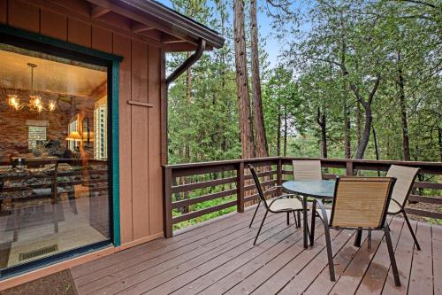 a wooden deck with a table and chairs on it at Elk Horn Retreat in Idyllwild