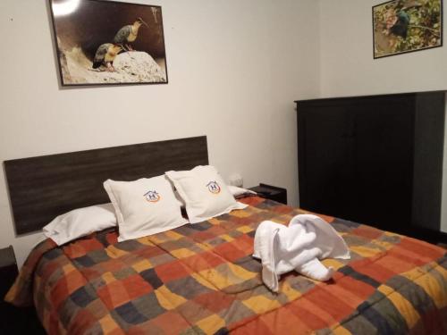 a bedroom with a bed with towels on it at Qoricancha B&B Cusco in Cusco