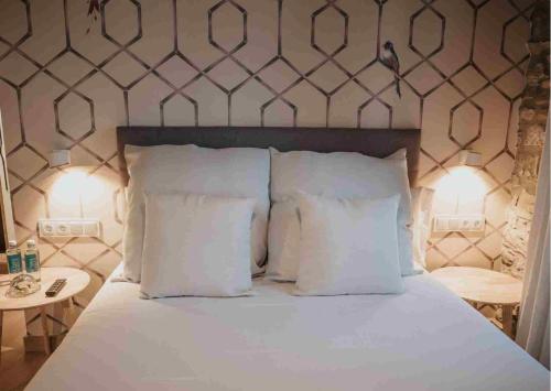 a bedroom with a bed with white pillows at Les Quingles in Calders