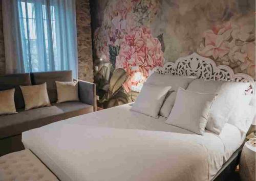 a bedroom with a white bed and a couch at Les Quingles in Calders