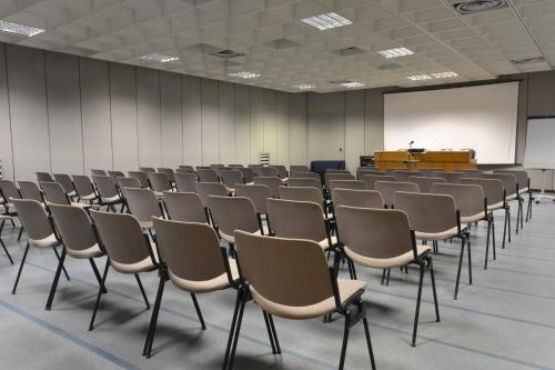 a room filled with chairs and a whiteboard at Grand Hotel Tiziano E Dei Congressi in Lecce