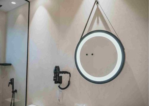 a mirror hanging on a wall in a bathroom at Les Quingles in Calders